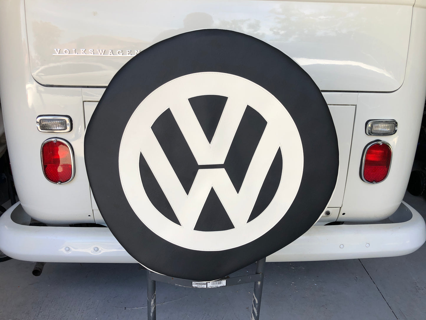 Spare wheel cover in Black with white logo.